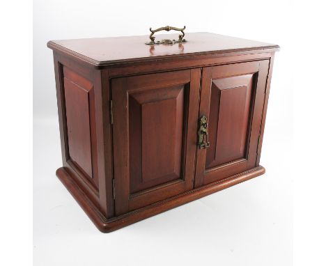 A 19th century red walnut table cabinet, with carrying handle and fitted with two fielded panel doors, width 21.5ins