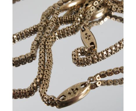 A guard chain, of pierced box links with fancy pierced panel links at intervals, tagged '9o', 148cm long, weight 23.8g gross