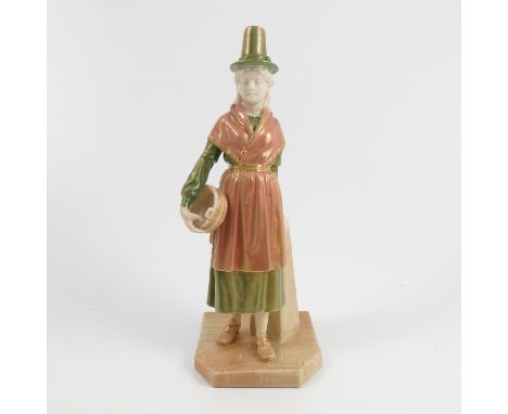 A Royal Worcester shot silk figure, from the Countries of the World series, Wales, woman wearing a Welsh hat and carrying a b
