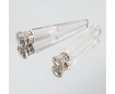Two silver mounted and glass scent bottles, the one marked Sterling, with embossed hinged top and tapering faceted glass body