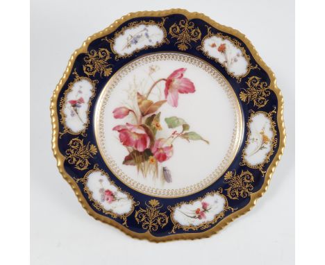A Royal Worcester plate, decorated with flowers and insects to the centre with a border of flowers in gilt framed reserves wi