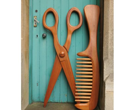 A large novelty pair of wooden scissors, together with a wooden comb, length 53ins