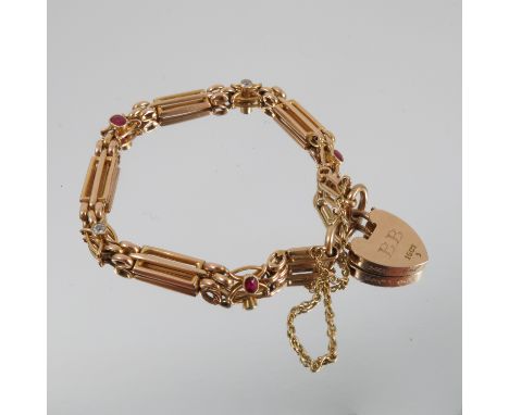 A diamond and ruby bracelet, tagged '15ct', of three bar gate link design, alternate set in between with two diamonds and thr