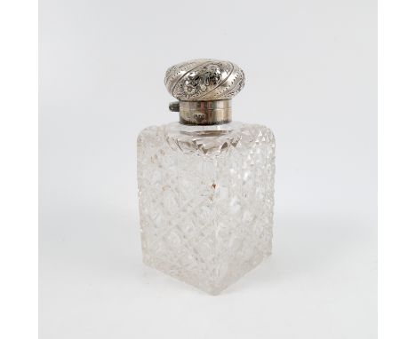 A 19th century cut glass and silver mounted perfume bottle, the rectangular bottle with repeating cut decoration, the silver 