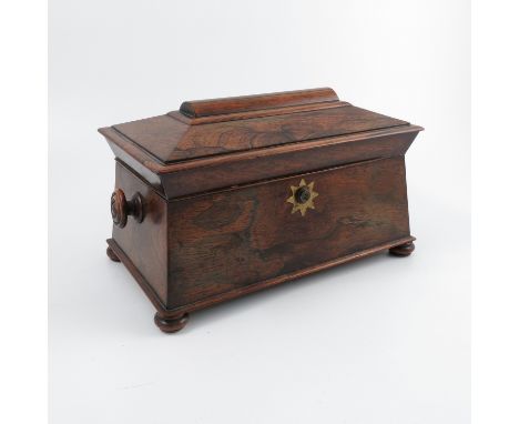 A 19th century rosewood tea caddy, of sarcophagus form, the interior fitted with two dome topped pull out caddies, flanking a