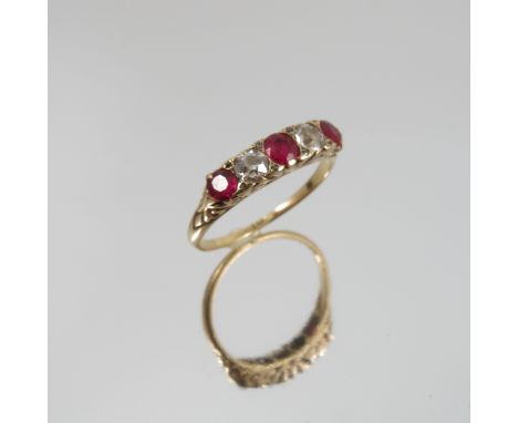 A five stone diamond and ruby Edwardian ring, stamped '18', the two old brilliant cuts totalling 0.3 carats, with rose diamon