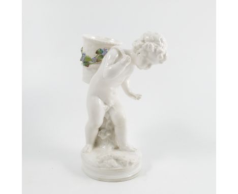 A Royal Worcester figure, modelled as a putti carrying a basket on his back with encrusted floral band, dated 1877, height 7.