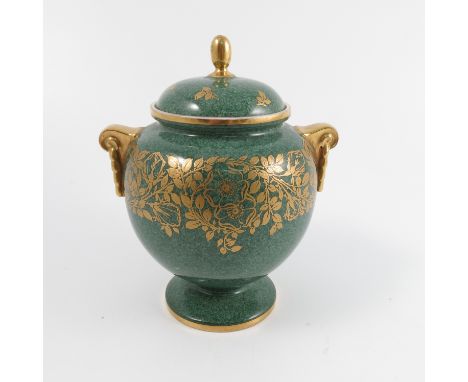 A Royal Worcester covered vase, the mottled green ground decorated in gilt leaves, raised on a circular foot, dated 1933, sha