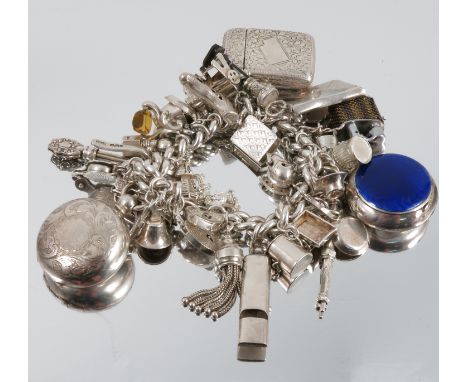 A silver bracelet, with numerous items and charms attached including a metal sovereign case, a vesta case, a napkin holder, a