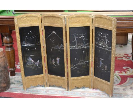 An oriental lacquered four fold firescreen.