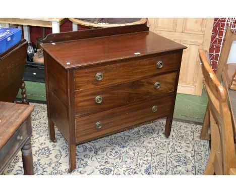 A mahogany chest, galleried back, oversailing top, three graduated drawers, brass roundels and loop handles, square supports,