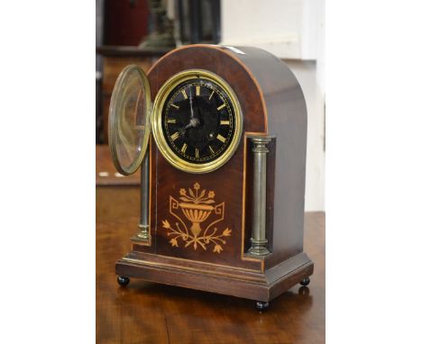 An Edwardian mahogany cased inlaid dome topped mantel clock, brass column pillars