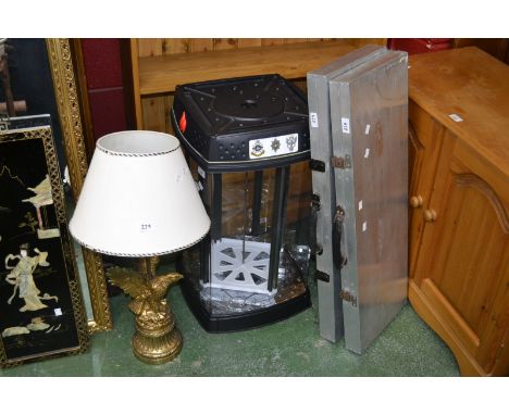 A modern counter top display cabinet; a modern lamp, in the form of an eagle; two aluminium carrying display cases