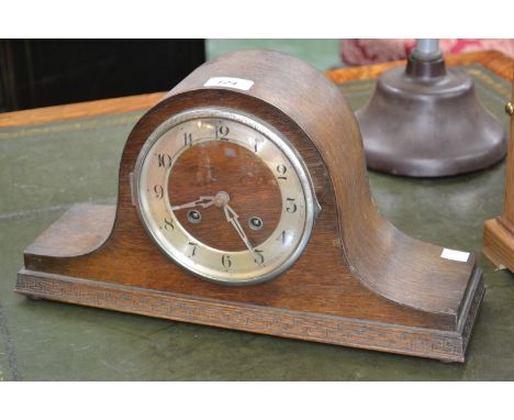 An oak cased chiming Napoleon hat mantel clock