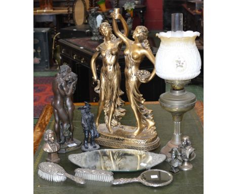 A three piece dressing table set on a mirrored tray; a figural group of gilt coloured maidens; another of a pair of lovers; a