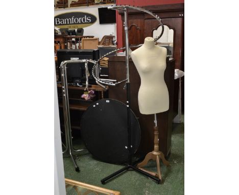 A shop display stand for clothes; another, similar; a mannequin, plinth base (4)