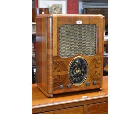 An Art Deco Ferguson 503AC walnut cased radio, oval black tuning scale, four rotating knobs, stepped walnut veneered case 