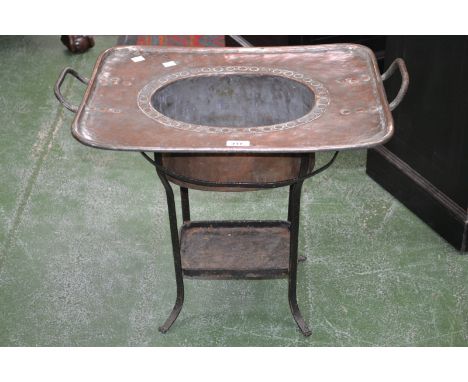 A French two handled copper basin, resting on a portable cast iron base, 63cm wide, 52cm high