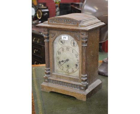 A 20th century oak dome topped mantel clock