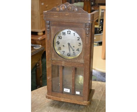 A mid-20th century Junghans oak cased wall clock, with key and pendulum