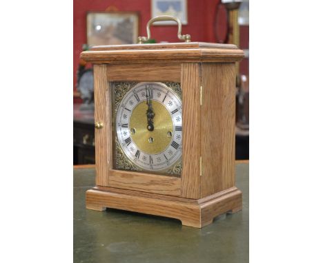 A Franz Hermle oak cased mantel clock, gilt face and spandrels, silvered chapter ring, Roman numerals, three winding holes.