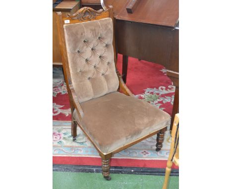 A Victorian mahogany fireside chair, carved top rail, button upholstered back, turned forelegs, ceramic casters, c.1880