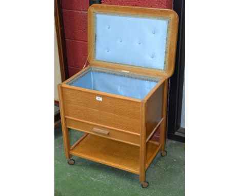 A Vintage oak sewing trolley, by C Arnold Ltd, Marlow, Bucks, hinged cover, lined box, single drawer and undertier.