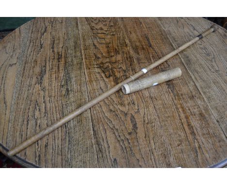 A tribal blow-pipe and quiver.