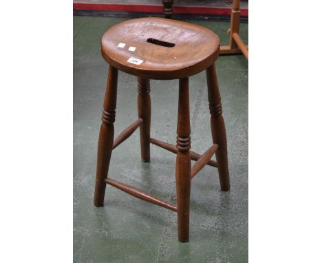 A light oak stool, round seat, turned legs and stretchers.