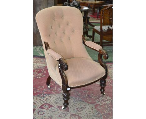 A 19th century mahogany button back open armchair, turned legs, ceramic casters, c.1840