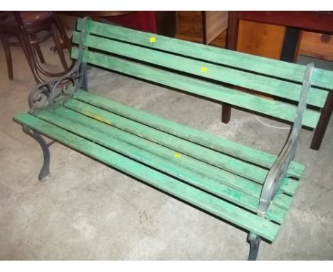 A GREEN WOODEN BENCH