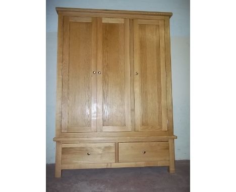 A MODERN LIGHT OAK TRIPLE WARDROBE