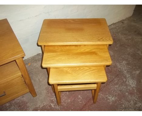 A LIGHT OAK NEST OF TABLES