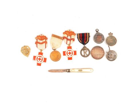 A collection of silver medallions and medals, including a silver and enamel British Red Cross Nursing Proficiency medal 1932 