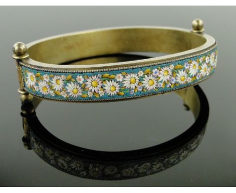A 19th century micro-mosaic hinged bangle,
with decorated panels depicting doves and flowers, silver gilt settings with indis