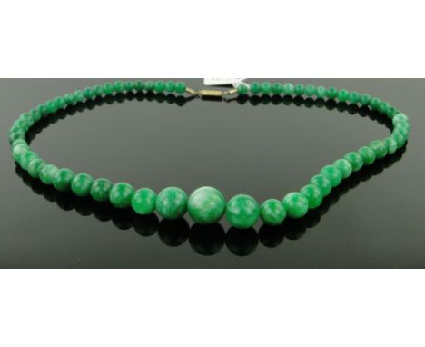 A string of polished jade beads, largest 14mm across.