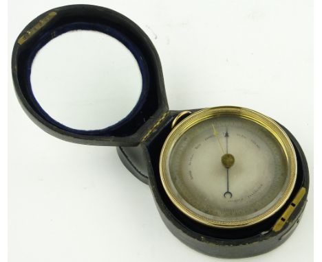 A brass aneroid barometer, diameter 4.75" 
complete with leather carrying case.