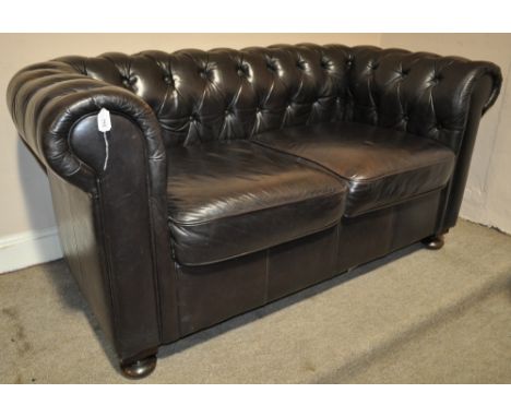 A brown buttoned leather upholstered Chesterfield sofa,
width 5'4, depth 33".