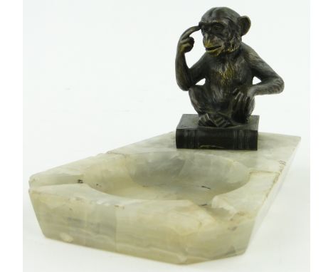 A bronze monkey sitting on a book, 
height 3" mounted on onyx base.