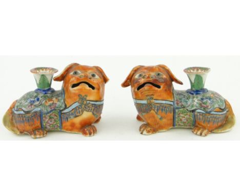 A pair of 19th century Canton enamel lion dog design taper holders,
length 4.75".