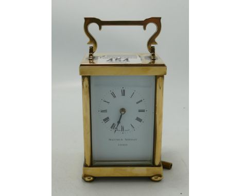 Brass cased carriage clock: Matthew Norman of London, Swiss movement.  Winds and ticks.  14.5cm high including handle. 
