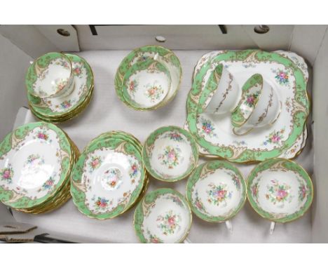 Tuscan green floral and gilded part tea set: to include 11 saucers, 12 side plates, 8 cups, sugar bowl and cake plate 