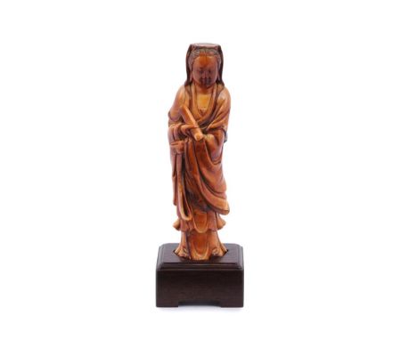 Y A small Chinese ivory figure of Guanyin, Ming-Qing Dynasty, 17th or 18th century, standing in long flowing robes and holdin