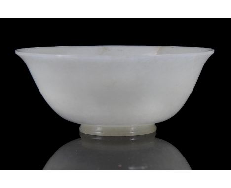 A Chinese pale celadon jade bowl, Qing Dynasty, the everted rim with one russet natural inclusion running down from the rim, 