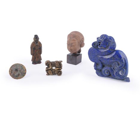 A Chinese gilt ink cake, 19th century, in the design of a standing scholar holding a circular disk, the reverse signed Hu Ziq