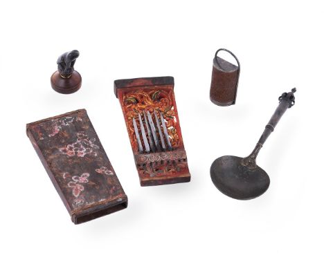 A group of mostly Indonesian objects, 19th or 20th century, comprising: a painted and carved wood container with steel cockfi