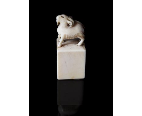 Y A Chinese uncut ivory seal, Qing Dynasty, 18th or first half of 19th century, carved with a ram, with paper Oriental Cerami