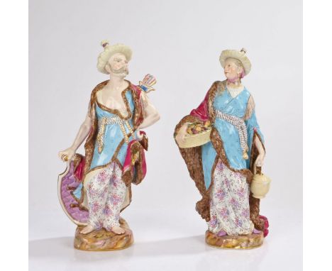 Meissen, Two figures from Malabar, circa 1860, both wearing straw hats and purple cloaks with fur lining, the male figure car