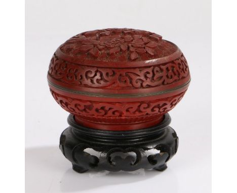 Chinese cinnabar lacquer box and cover, the foliate carved lid opening to reveal a blue enamel interior, raised on a pierced 