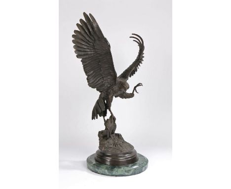 After Jules Moigniez (1835-1894), a large bronze sculpture of an eagle with prey, signed to the naturalistic base, raised on 